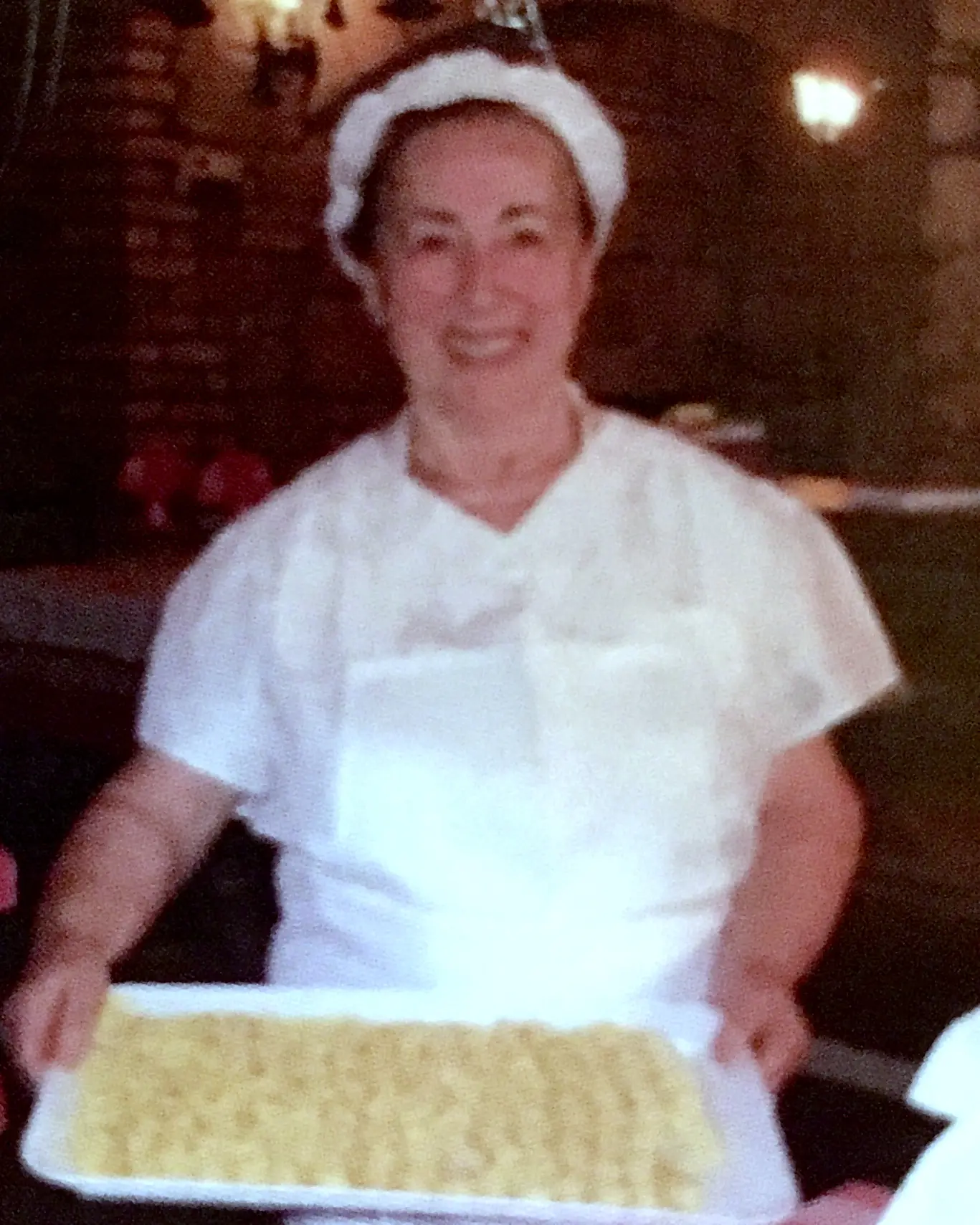Piera holding a tray of homemade pasta